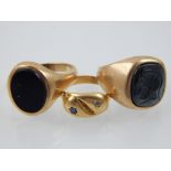 A 9ct gold gentleman's signet ring, set with a carved hardstone, together with two further rings,