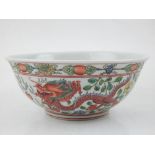 A Chinese porcelain bowl, polychrome decorated with dragons and phoenixes amongst stylised flowers.