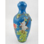 A Chinese blue ground porcelain vase, moulded with cranes and floral decoration,
