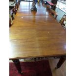 A Victorian mahogany extending dining table, the rectangular moulded top with four leaf insertions,