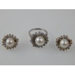 An 18ct white gold, cultured pearl and diamond dress ring of cluster form with wirework surround,