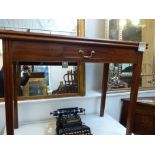 A George III mahogany tea table, the rectangular top above a gate-leg action and a frieze drawer,
