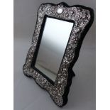 A Victorian style rectangular white metal easel mirror, embossed with scrolling flowers. H.