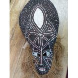 An African mask, painted hessian with a beard, H.