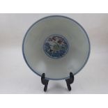 A Chinese doucai porcelain bowl, decorated with vignettes of stylised flowers and scrolling foliage,