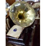 A vintage style gramophone, with a mahogany case and brass sound horn,