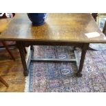 An Arts and Crafts style oak side table, the rectangular top above a peripheral drawer,