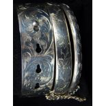 A silver Charles Horner bangle, together with a smaller Charles Horner example, and a silver bangle,