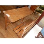 A late 19th century oak and beech double school desk, with slanted writing surface with integral