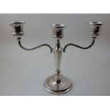 A silver three branch candelabra, Birmingham 1975 by Broadway and Co. with a tapering support and