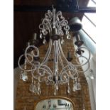 A contemporary seven branch chandelier, the bronzed frame decorated with beads and drops, H.