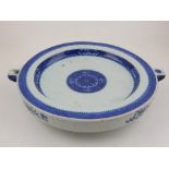 A late 19th century Chinese plate warmer, decorated in blue and white bands with floral vignettes,