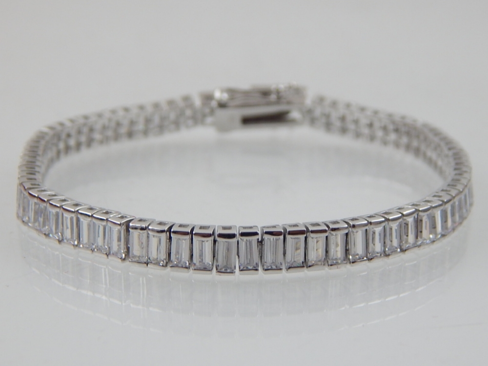 A silver and cubic zirconia tennis bracelet.