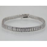 A silver and cubic zirconia tennis bracelet.