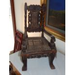A 17th century style child's chair, with cane upholstered back and seat with open arms,