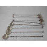 A set of eight white metal cocktail stirrers, with shell bowls and twisted stems. L. 25cm (8)