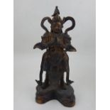 A Tibetan bronze figure of the Bodhisattva Skanda, dressed as a warrior, raised on stepped base. H.
