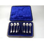 A cased set of six coffee spoons and a pair of sugar tongs, with trifid ends, Sheffield 1922.