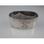 A silver oval napkin ring, Birmingham 1930, together with a white metal preserve pot, having pierced