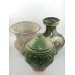 An early Chinese green glazed terracotta lidded pot, impressed with poppies, H.