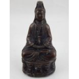 A bronze figure of Guanlin, seated on a lotus flower and six character mark to base, H.