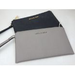 A Michael Kors ladies black leather clutch, together with one light grey clutch of similar design.