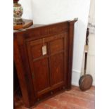 A George III oak and mahogany hanging corner cupboard,