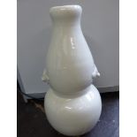 A Chinese blanc de chine double gourd vase, with moulded bat twin handles, H. 52cm.