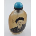 A Chinese reverse painted glass snuff bottle, with cabouchon stopper,