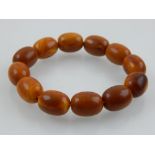 An amber coloured beaded bracelet.