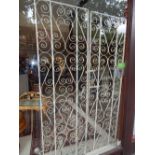 A pair of mid 20th century wrought steel garden gates, of decorative vase and scroll construction,