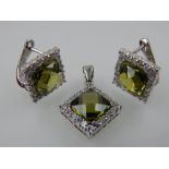 A pair of silver, cubic zirconia and green tourmaline earrings, and matching pendant.