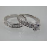 A silver and cubic zirconia ring and band set circular and baguette stones.