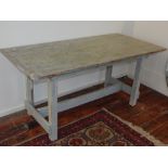 A contemporary grey painted plank top table, with cleated ends and raised on square legs, L.