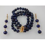 A cultured blue pearl three strand bracelet, with 14ct yellow gold clasp, together with a pair of