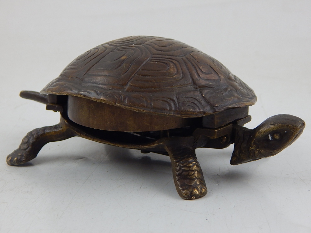 A bronze table bell, modelled in the form of a tortoise,