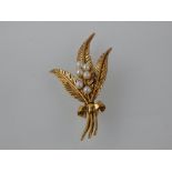 A 9ct yellow gold and seed pearl tied floral brooch.