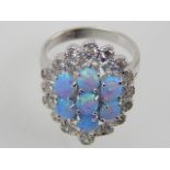 A silver, opalite and cubic zirconia dress ring.