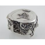 A late 19th century silver box, modelled in the form of a stump, decorated with trailing flowers,