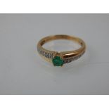 An emerald and diamond ring, the central square claw set stone in a 9ct yellow gold band.