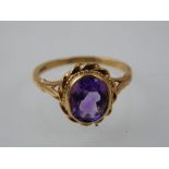 An amethyst dress ring, the oval faceted stone within a rope twist mount and 9ct band.