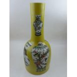 A Chinese large bottle vase, decorated with images of famille vert vases on a yellow ground, H,