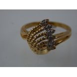 A diamond floral spray dress ring, with rope twist strands in a 10ct yellow gold band.