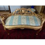 A Victorian style gilt frame window seat with pierced cartouche back, raised on cabriole on legs.