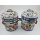 A pair of Chinese vases with domed covers, decorated with figures in a landscape, H 17cm.