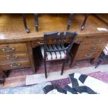 A large late 19th century oak tambour top desk, enclosing a fitted interior,