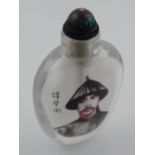 A Chinese reverse painted glass snuff bottle, decorated with a man in traditional dress,