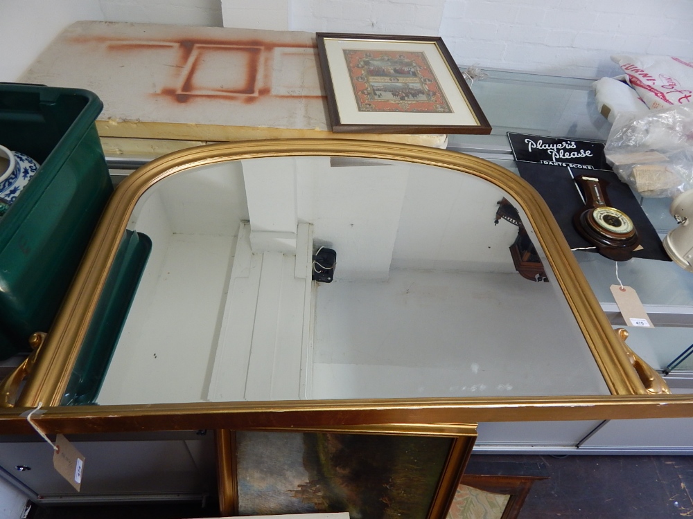 A Victorian style overmantel mirror, the arched bevelled plate within a gilt frame, W.