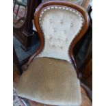 A Victorian mahogany framed spoon back button upholstered chair, covered in fawn fabric,