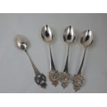 A set of four Edwardian silver table spoons, Sheffield 1906, the terminals with crest of rearing